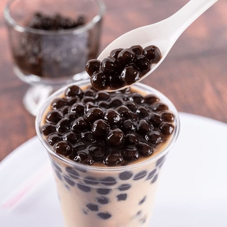Brown sugar boba milk tea in a clear cup